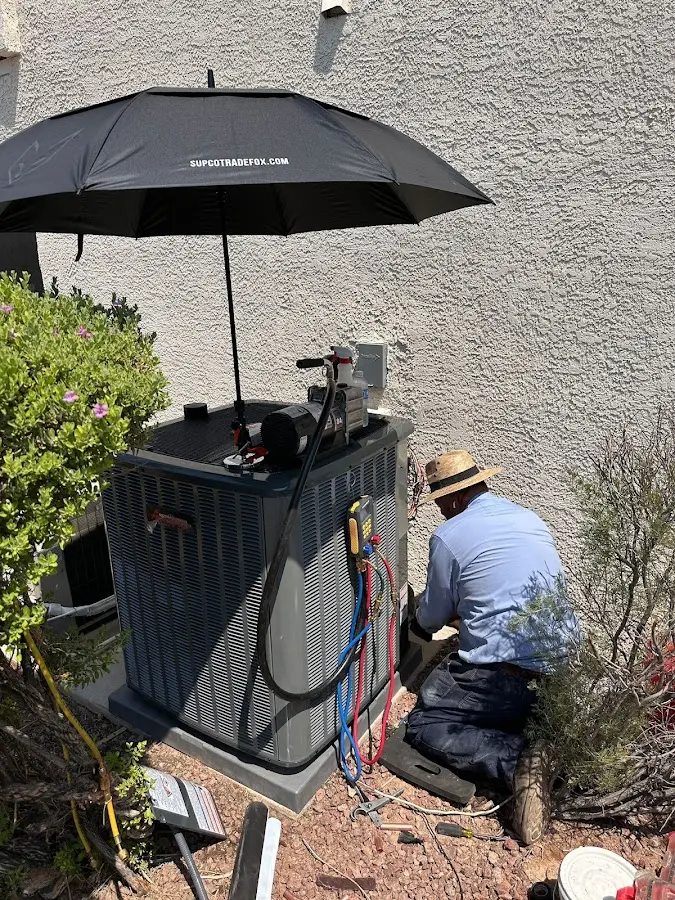HVAC technician performing outdoor AC maintenance in Richmond West